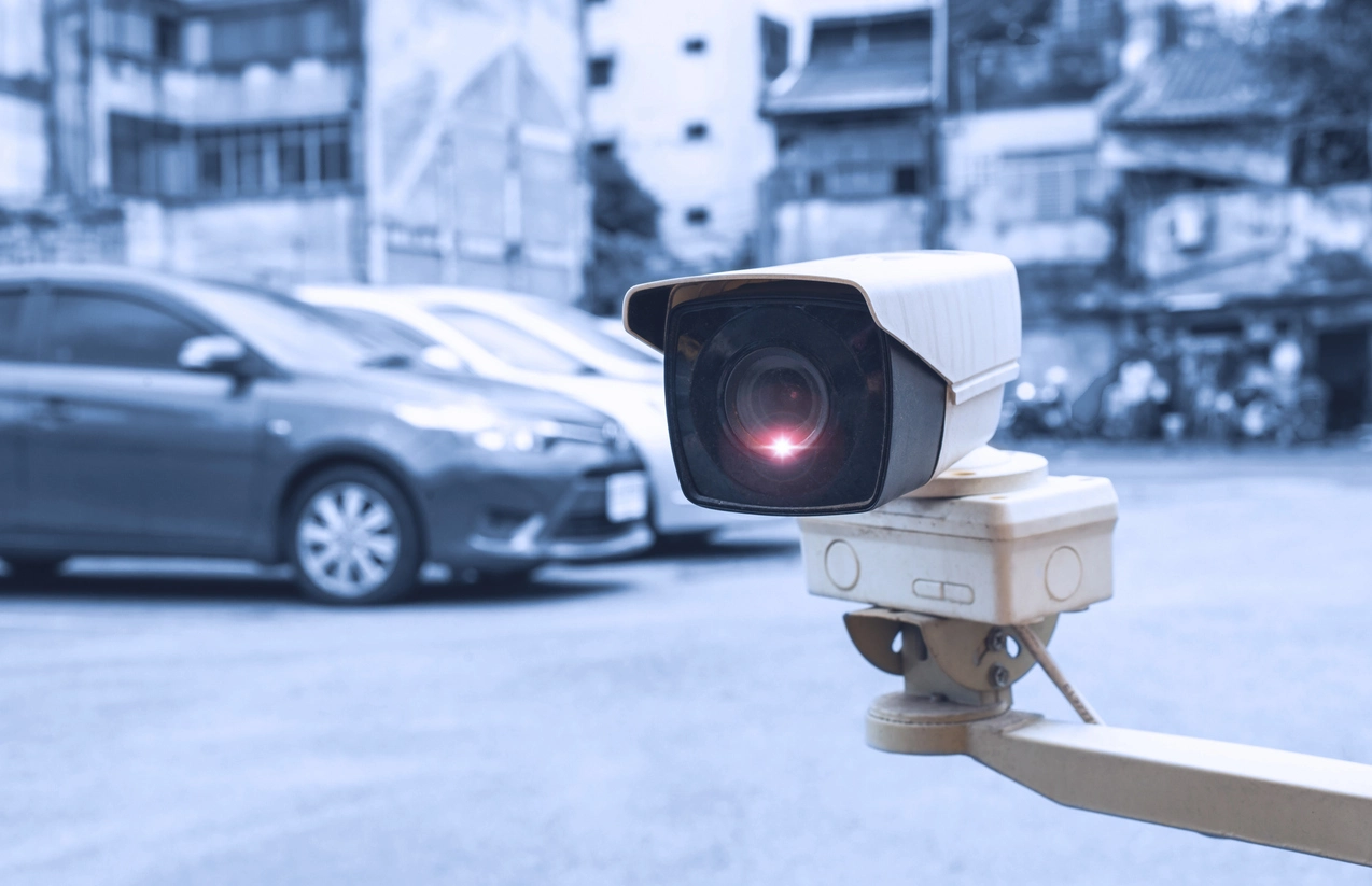 commercial parking lot monitored by nighttime security cameras