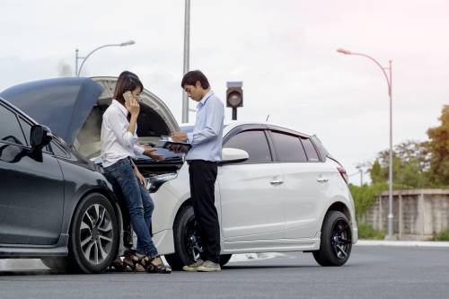 People exchanging insurance information after a car crash